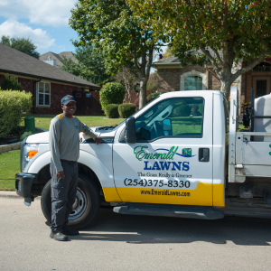 Emerald Lawns technician servicing property.