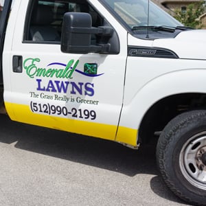 Close-up of an Emerald Lawns service truck in Fort Worth, TX