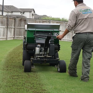 Emerald Lawns team member aerating a customer’s lawn in Euless, TX