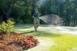 lawn technician spraying for lawn disease on springdale lawn